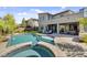 A luxurious backyard oasis with a sparkling pool, spa, patio, and elegant landscaping at 6491 Wild Blue Ct, Las Vegas, NV 89135