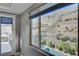 Window with a view of the outdoor pool and landscaping, complemented by a patio with comfortable seating at 6491 Wild Blue Ct, Las Vegas, NV 89135