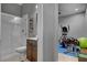 An en-suite bathroom with a glass shower and a view into the exercise room at 6491 Wild Blue Ct, Las Vegas, NV 89135