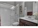 A bathroom with a dark vanity, white countertop, toilet and glass shower at 6491 Wild Blue Ct, Las Vegas, NV 89135