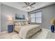 Bedroom featuring a ceiling fan, hardwood floors, and a patterned bedspread at 6491 Wild Blue Ct, Las Vegas, NV 89135