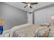 Bedroom featuring a ceiling fan, hardwood floors, a patterned bedspread and a closet at 6491 Wild Blue Ct, Las Vegas, NV 89135