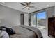 Bright bedroom with a ceiling fan, sliding glass door to a patio, and stylish, neutral decor at 6491 Wild Blue Ct, Las Vegas, NV 89135