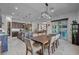 Open concept dining room showcasing modern furnishings, open access to the kitchen, and views of the backyard at 6491 Wild Blue Ct, Las Vegas, NV 89135