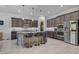 The gourmet kitchen boasts a large island with seating and modern stainless steel appliances at 6491 Wild Blue Ct, Las Vegas, NV 89135