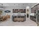 Open-concept kitchen featuring a large island with seating, stainless steel appliances, and modern light fixtures at 6491 Wild Blue Ct, Las Vegas, NV 89135