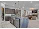 Spacious kitchen with a large island, stainless steel appliances, and open access to the living room and staircase at 6491 Wild Blue Ct, Las Vegas, NV 89135