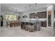 Open-concept kitchen featuring a large island with seating, stainless steel appliances, and an adjacent dining area at 6491 Wild Blue Ct, Las Vegas, NV 89135