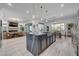 The gourmet kitchen overlooks the living room and dining room, boasting a large island with seating at 6491 Wild Blue Ct, Las Vegas, NV 89135