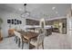 The open concept kitchen and dining features a large island, stainless appliances and wood flooring at 6491 Wild Blue Ct, Las Vegas, NV 89135