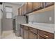 Functional laundry room with modern washer and dryer, sleek countertops, and ample cabinet space at 6491 Wild Blue Ct, Las Vegas, NV 89135