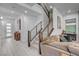 Bright, modern living room with wood floors, staircase and designer touches, creating a welcoming space at 6491 Wild Blue Ct, Las Vegas, NV 89135