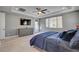 Bedroom featuring hardwood floors, ceiling fan, large window, and a mounted television at 6491 Wild Blue Ct, Las Vegas, NV 89135