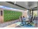 Covered outdoor dining area with an integrated green wall that adds a natural element at 6491 Wild Blue Ct, Las Vegas, NV 89135