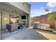 Outdoor living space featuring a built-in grill, fireplace, and comfortable seating area at 6491 Wild Blue Ct, Las Vegas, NV 89135