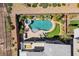 Backyard pool area featuring a lush landscaping with manicured hedges and artificial grass at 6491 Wild Blue Ct, Las Vegas, NV 89135