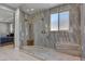 Shower featuring stone-look walls, dual shower heads, and a built-in bench at 6491 Wild Blue Ct, Las Vegas, NV 89135