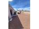View of backyard that has landscaping in rock and fence with some trees and grass at 6628 Martinsville Pl, Las Vegas, NV 89110
