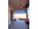 Outdoor patio area with awning, fan and view of fenced backyard space and landscaping at 6628 Martinsville Pl, Las Vegas, NV 89110