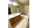 Bright bathroom features a vanity, a tub-shower, and tile flooring at 6628 Martinsville Pl, Las Vegas, NV 89110