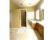 Bright bathroom featuring a large tub, tiled shower, and neutral tile floors at 6628 Martinsville Pl, Las Vegas, NV 89110