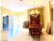 Large dining room with a wooden dining table and chandelier lighting at 6628 Martinsville Pl, Las Vegas, NV 89110