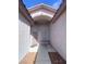 Inviting entryway featuring an arched doorway, decorative windows, and a stylish front door at 6628 Martinsville Pl, Las Vegas, NV 89110