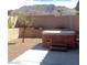 Backyard view of an in-ground hot tub situated in a yard with mountain views at 6628 Martinsville Pl, Las Vegas, NV 89110