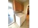 Bright laundry room with a washer, dryer, and door to the garage at 6628 Martinsville Pl, Las Vegas, NV 89110