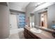 Bathroom featuring a large mirror and shower-over-tub at 6650 W Warm Springs Rd # 1079, Las Vegas, NV 89118
