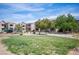 Well-manicured common area with lush green grass, trees, and a playground creating a welcoming outdoor space at 6650 W Warm Springs Rd # 1079, Las Vegas, NV 89118