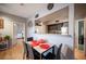 Dining area showcases a modern table set adjacent to a partial wall opening into the stainless steel appliance-equipped kitchen at 6650 W Warm Springs Rd # 1079, Las Vegas, NV 89118