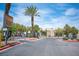 Gated community entrance providing security and privacy, with lush landscaping and a palm tree at 6650 W Warm Springs Rd # 1079, Las Vegas, NV 89118