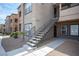 Apartment building featuring a modern design, exterior staircase, and well-maintained landscaping at 6650 W Warm Springs Rd # 1079, Las Vegas, NV 89118