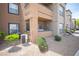 Exterior of an apartment building with well-kept landscaping, featuring a small patio at 6650 W Warm Springs Rd # 1079, Las Vegas, NV 89118