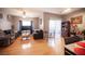 Spacious living room features ample seating, a ceiling fan, and a sliding glass door for plenty of natural light at 6650 W Warm Springs Rd # 1079, Las Vegas, NV 89118
