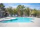 Community pool and hot tub surrounded by lounge chairs and lush landscaping, creating a relaxing atmosphere at 6650 W Warm Springs Rd # 1079, Las Vegas, NV 89118