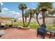 Private backyard features a brick patio and a small landscape with palm trees at 6712 Kittery Dr, Las Vegas, NV 89107