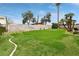 Expansive backyard featuring a verdant lawn and mature trees, perfect for outdoor activities and relaxation at 6712 Kittery Dr, Las Vegas, NV 89107