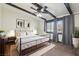 Bright bedroom with wooden beam ceiling, ceiling fan, and large windows at 6712 Kittery Dr, Las Vegas, NV 89107