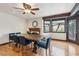 Charming dining room featuring a wooden table, blue chairs, natural lighting, and hardwood floors at 6712 Kittery Dr, Las Vegas, NV 89107