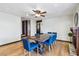 Bright dining room with a wooden table, blue chairs, a fireplace, and hardwood flooring at 6712 Kittery Dr, Las Vegas, NV 89107