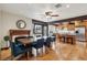 Open dining room flowing to the kitchen with wooden table, blue chairs, and stainless steel appliances at 6712 Kittery Dr, Las Vegas, NV 89107