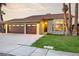 Charming single-story home with a three-car garage, lush lawn, and stone veneer accents at 6712 Kittery Dr, Las Vegas, NV 89107