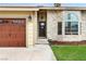 Welcoming front entrance with a brick facade, a manicured lawn, and a charming front door at 6712 Kittery Dr, Las Vegas, NV 89107