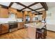 Well-lit kitchen features stainless steel appliances, a tiled backsplash, and hardwood flooring at 6712 Kittery Dr, Las Vegas, NV 89107