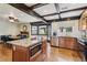 A modern kitchen with an island and granite countertops that opens to the dining area and backyard at 6712 Kittery Dr, Las Vegas, NV 89107