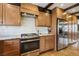 A chef's kitchen with stainless steel appliances, custom wood cabinets, and modern finishes at 6712 Kittery Dr, Las Vegas, NV 89107