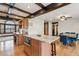 Open kitchen and dining area with island, custom cabinetry, and hardwood floors at 6712 Kittery Dr, Las Vegas, NV 89107