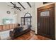 Inviting living room with hardwood flooring, beamed ceilings, and natural light from a large window at 6712 Kittery Dr, Las Vegas, NV 89107